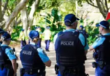 Crime in Sydney Australia. Close up of a NSW Police officers uniform sleeve patch and his communication device. Sydney^ NSW Australia - October 6 2024
