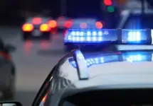 police patrol car with blue flashing light on the roof of the police car. Alarming in the evening.