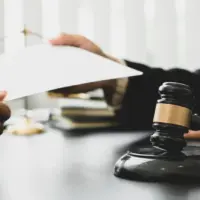 Consulting and finding a solution Concept^ businesspeople consult with a lawyer or judge to find out about business fraud.