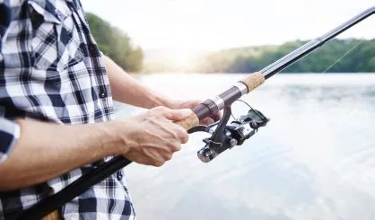 human-hand-holding-fishing-rod