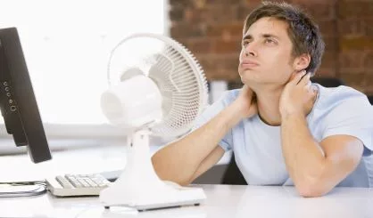 businessman-in-office-with-computer-and-fan-cooling-off