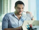 ex-smoker-man-smoking-electronic-cigarette-in-office-while-working