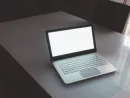 laptop-with-black-screen-on-table-business-technology-concept