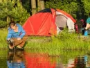 camping-couple-heating-supper-and-washing-pot
