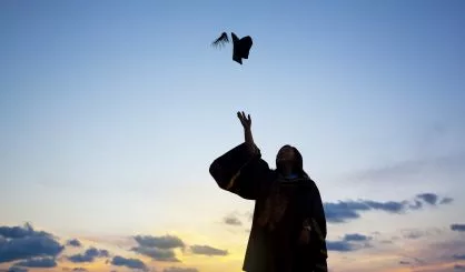 silhouette-of-young-female-student-celebrating-graduation