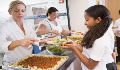 schoolgirl-holding-plate-of-lunch-in-school-cafeteria-2