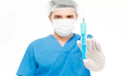male-surgeon-holding-syringe