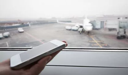 hand-with-smart-phone-by-the-window-at-airport