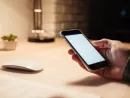 man-hand-holding-blank-screen-mobile-phone-ath-the-table