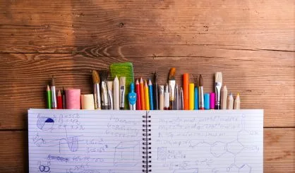 various-school-and-art-supplies-wooden-table-copy-space