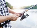 human-hand-holding-fishing-rod-2