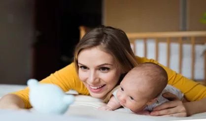 mother-with-her-newborn-baby-son-lying-on-bed