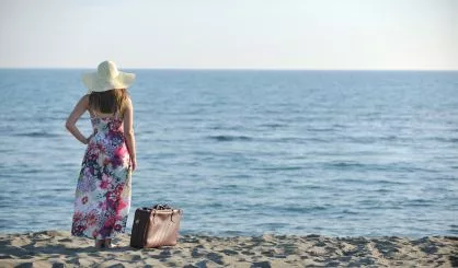 woman-with-suitcase-on-the-beach