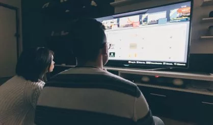 back-view-of-couple-indoor-watching-tv-relaxing