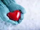 woman-hands-in-light-teal-knitted-mittens-are-holding-a-beautifu