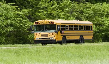 school-bus-traveling-on-interstate-in-springtime