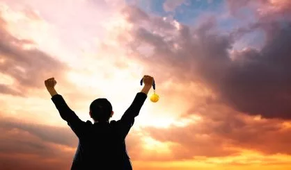 win-concept-businessman-holding-gold-medal