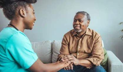 close-up-of-home-caregiver-and-senior-woman-holding-hands-profe