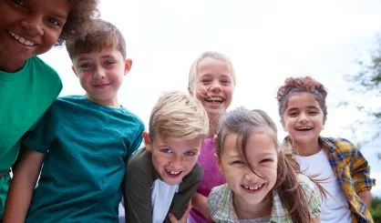 portrait-of-children-on-outdoor-activity-camping-trip-having-fun-playing-game-together