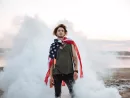 brutal-man-wearing-usa-flag-cape-posing-in-white-smoke