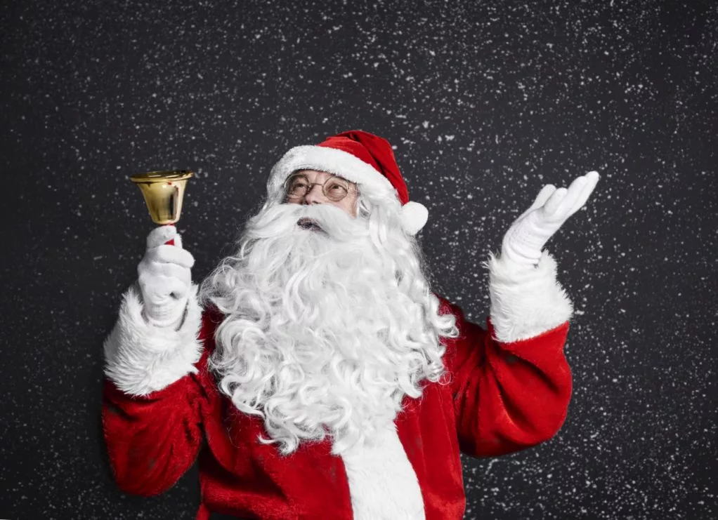 santa-claus-with-handbell-among-snow-falling