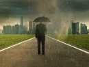 businessman-below-storm-rain-with-umbrella-risk-and-crisis-concept