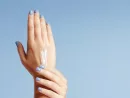 womans-hands-closeup-isolated-on-light-blue