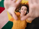 portrait-of-a-young-smiling-girl-in-headphones-enjoying-music