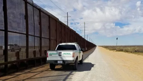 U.S. Customs and Border Patrol vehicle drives along the U.S.-Mexico border. El Paso^ Texas / USA - March 7^ 2020