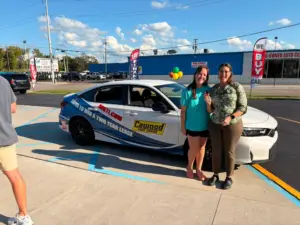 Lizzy G handing the keys to grand prize winner Christen Renn from Lexington!