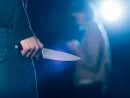 cropped-view-of-killer-holding-knife-near-woman-on-black