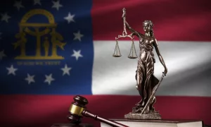 Georgia US state flag with statue of lady justice^ constitution and judge hammer on black drapery