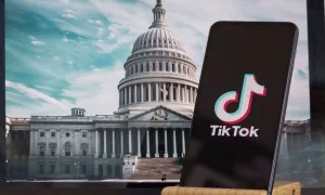 TikTok sign is sharp in the foreground^ while American Congress building is blurred in the background^ concept for TikTok ban in the United States^ USA^ March 8^ 2024