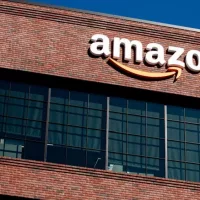 Closeup of Amazon logo on the company office building in East Palo Alto^ Silicon Valley^ San Francisco Bay Area. Amazon sign on brick building wall East Palo Alto^ California US - October 17^ 2024