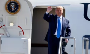 President Donald Trump waves as he steps off Air Force One at John Wayne Airport^ Santa Ana^ Calif.^ on Sunday Oct. 18^ 2020.