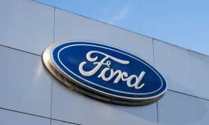 Closeup of the Ford logo seen at a Ford dealership store in Sunnyvale^ California. Ford Motor Company is an American multinational automobile manufacturer. Sunnyvale^ CA^ USA - Nov 22^ 2023