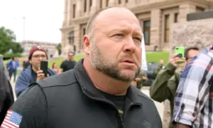 Alex Jones^ flanked by bodyguards^ leaves a rally protesting Covid-19 stay at home orders at the Capitol that was heavily promoted by his Infowars website. Austin^ Tx/USA - Apr. 18^ 2020