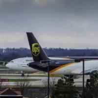 Louisville^ KY—March 6^ 2018 air cargo planes taxi to end of runway prior to take off