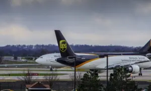 Louisville^ KY—March 6^ 2018 air cargo planes taxi to end of runway prior to take off