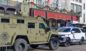 City police^ state police and Homeland Security officers^ and an armored vehicle and state patrol vehicle on Canal Street near the entrance to Bourbon Street New Orleans^ LA^ USA - January 2^ 2025