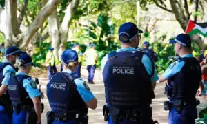 Crime in Sydney Australia. Close up of a NSW Police officers uniform sleeve patch and his communication device. Sydney^ NSW Australia - October 6 2024