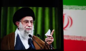 This image captures Iranian Supreme Leader Ali Khamenei giving a speech^ with the Iranian flag prominently displayed.