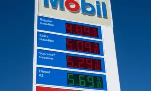 Mobil gas station sign showing high price of California Gasoline with bright blue sky Lone Pine^ CA^ USA - February 9th^ 2023