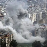 Large plumes of grey smoke billow from mult story apartment buildings following an explosion in a densely populated city^ depicting the devastation of modern urban warfare. Jan 28 2026 in USA