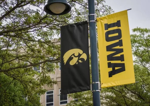 University of Iowa banner with Hawkeyes logo on college campus. Iowa City^ IA - May 23^ 2022: