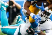 Dolphins linebacker Jerome Baker (55) tackled by Los Angeles Chargers running back Austin Ekeler (30) during an game^ Sept. 10^ 2023^ in Inglewood^ Calif.