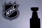 National Hockey LeagueLogo of NHL club on the screen. Stenley Cup Trophy Silhouette.