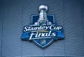 the front facade of a hockey arena with the NHL Stanley Cup Finals logo on the front of the building.