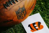 Cincinnati Bengals NFL team Logo and American football ball on Green Grass. CINCINNATI^ USA^ FEBRUARY 10^ 2025