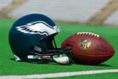 Philadelphia eagles equipment ^ ball and helmet on the green playing field ^ product shot AUGUST 13^ 2015